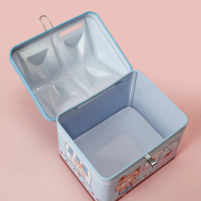 Blue house-shaped tinplate piggy bank on desktop with coin slot