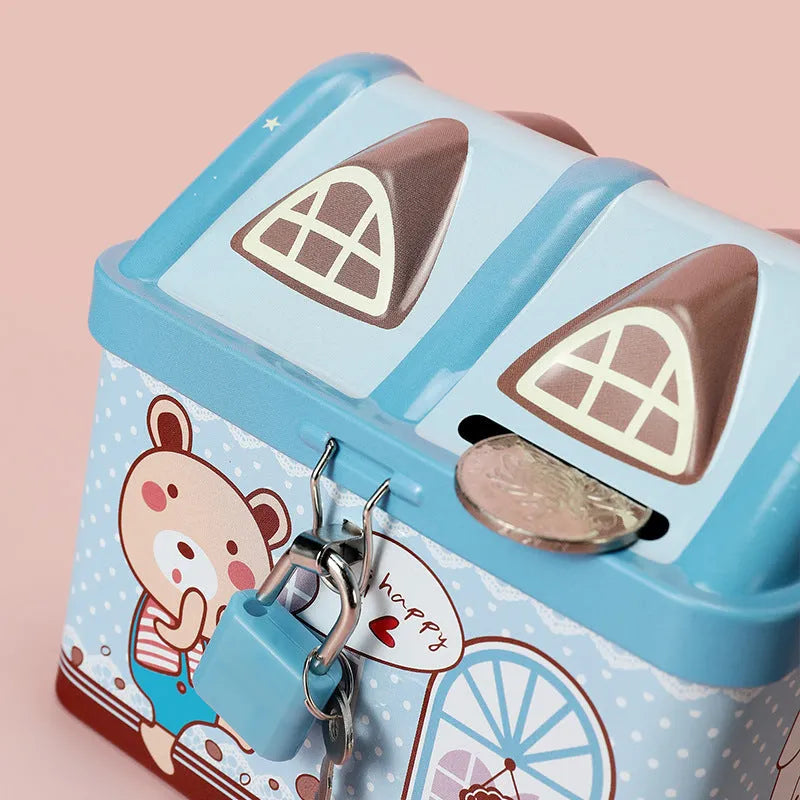 Blue house-shaped tinplate piggy bank on desktop with coin slot