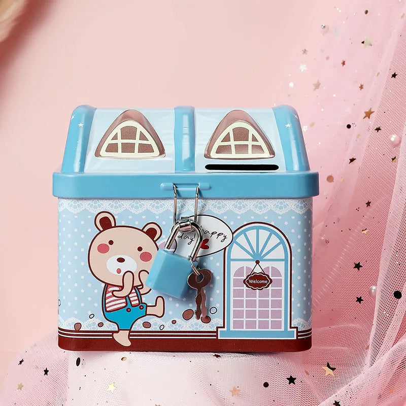 Blue house-shaped tinplate piggy bank on desktop with coin slot