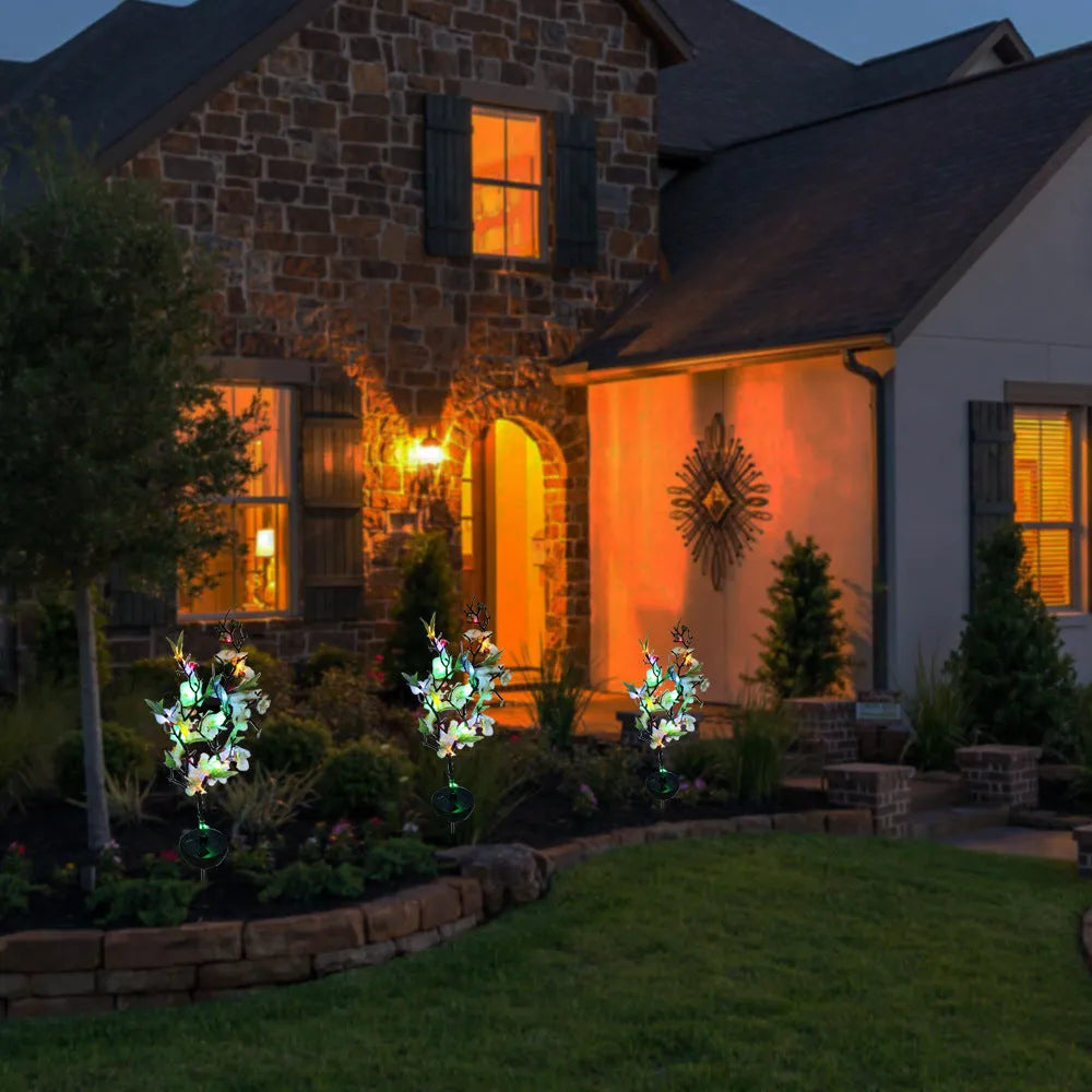 Solar-powered cherry blossom firework string light with ground stake for outdoor garden.