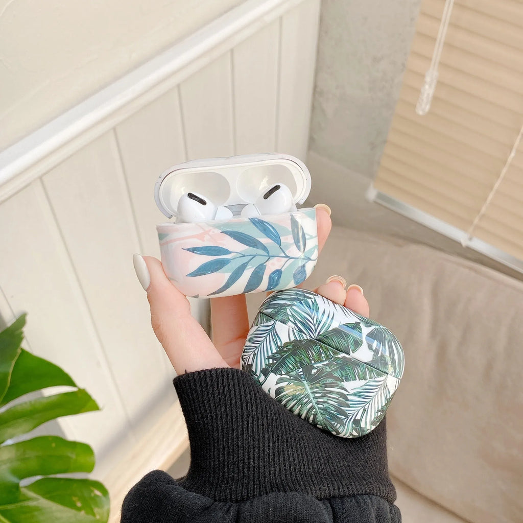 Soft blue TPU AirPods protective case with printed banana leaves tropical design.