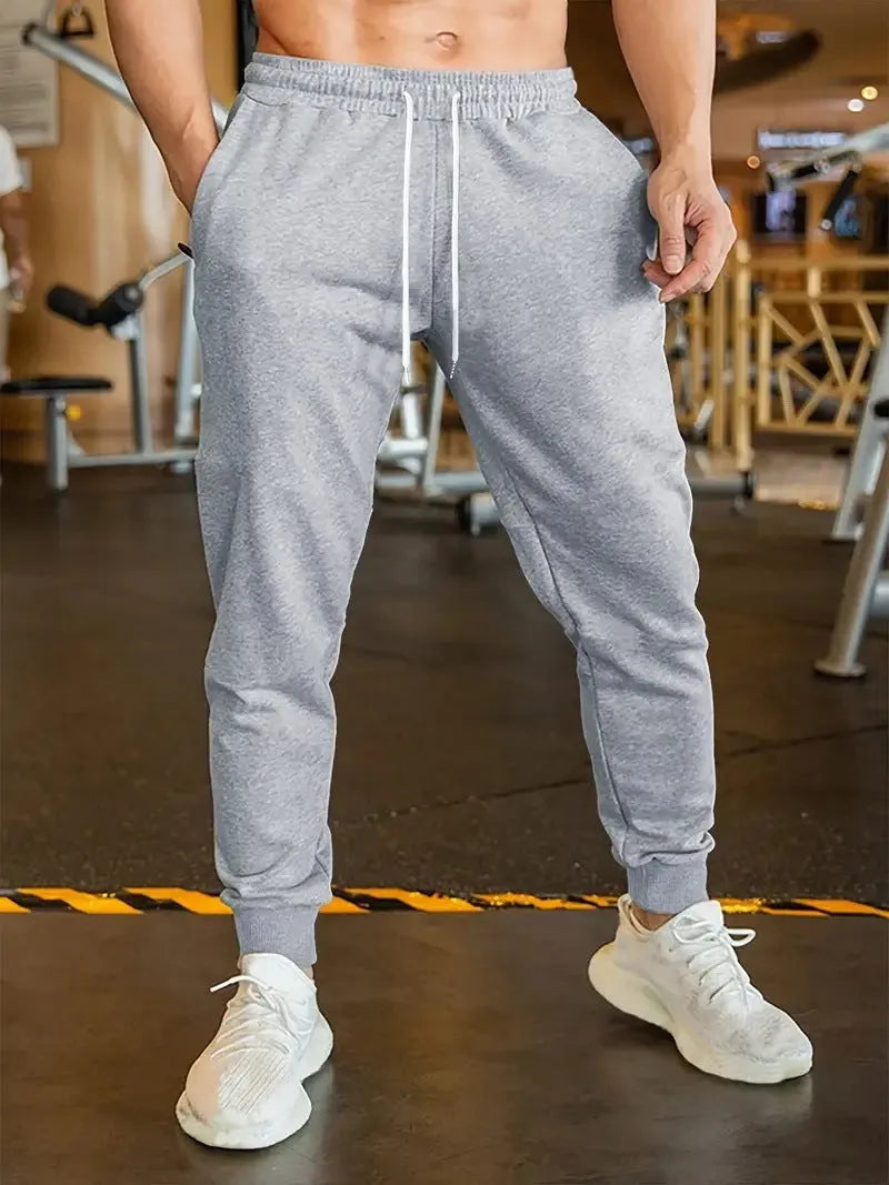 Men's elastic waist leisure trousers with drawstring closure and loose fit in polyester fabric