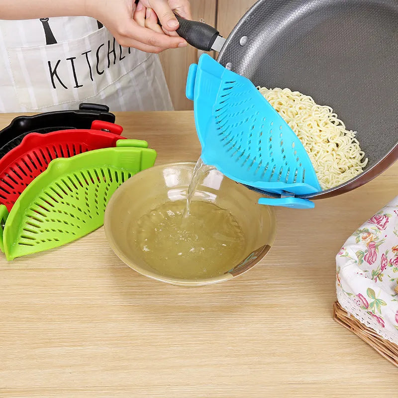 Silicone clip-on kitchen strainer attached to pot rim draining liquid
