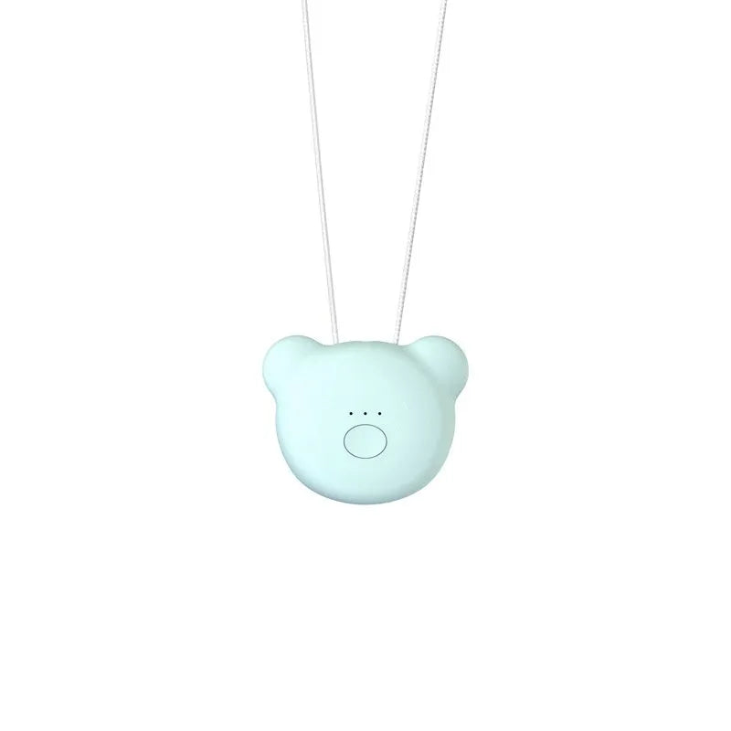 Small pink wearable USB air purifier necklace on a person, showing compact size.
