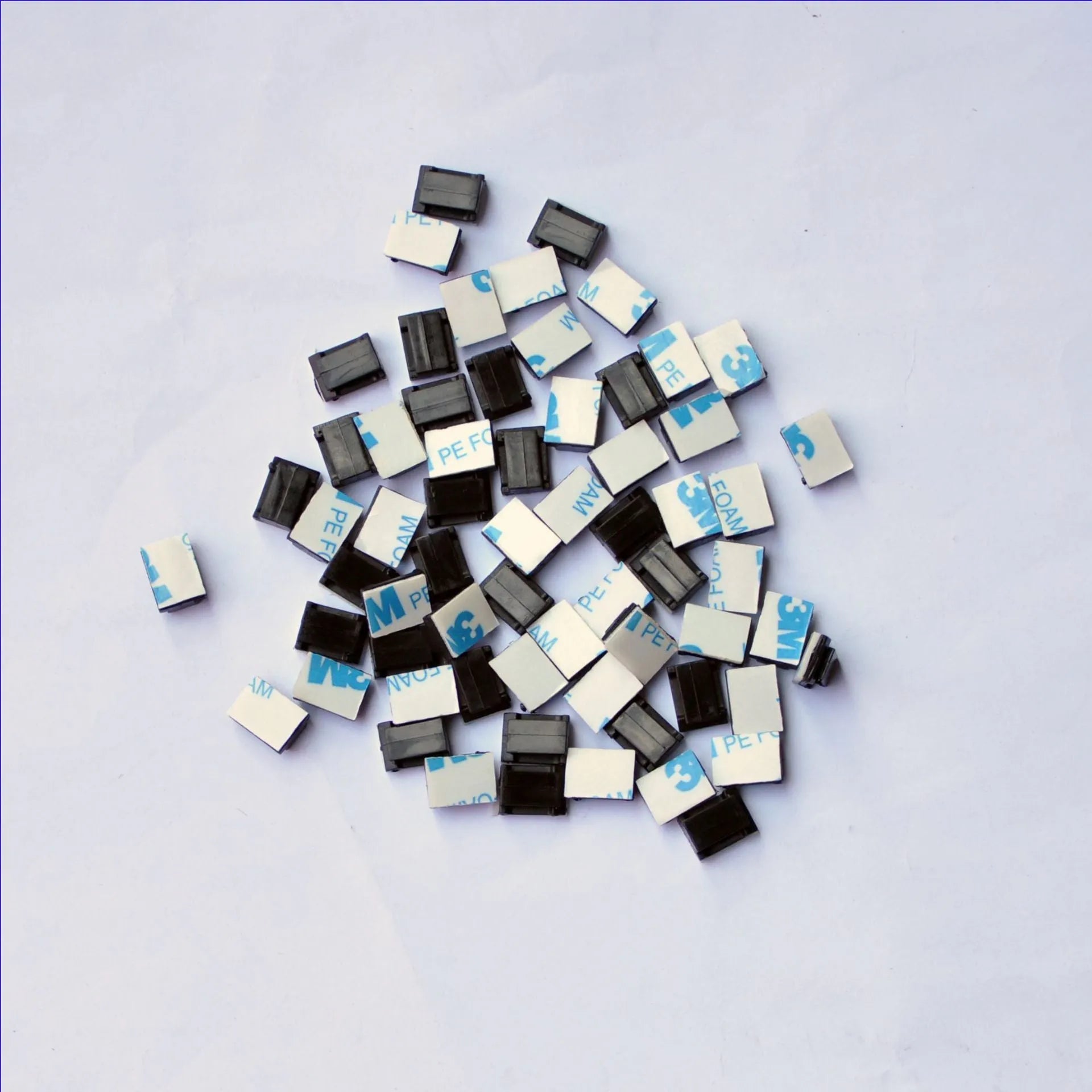 Black PA66 plastic wiring management clips for automotive and electronic cable organisation.