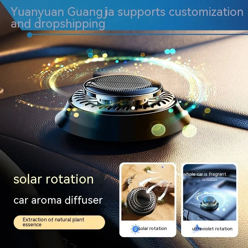 Solar-powered kinetic car air freshener with rotating double rings on a black dashboard.