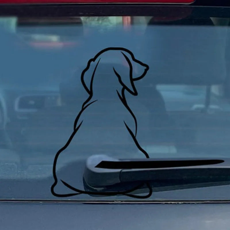 Cartoon dog car window sticker with rear wiper design and wagging tail on vehicle glass