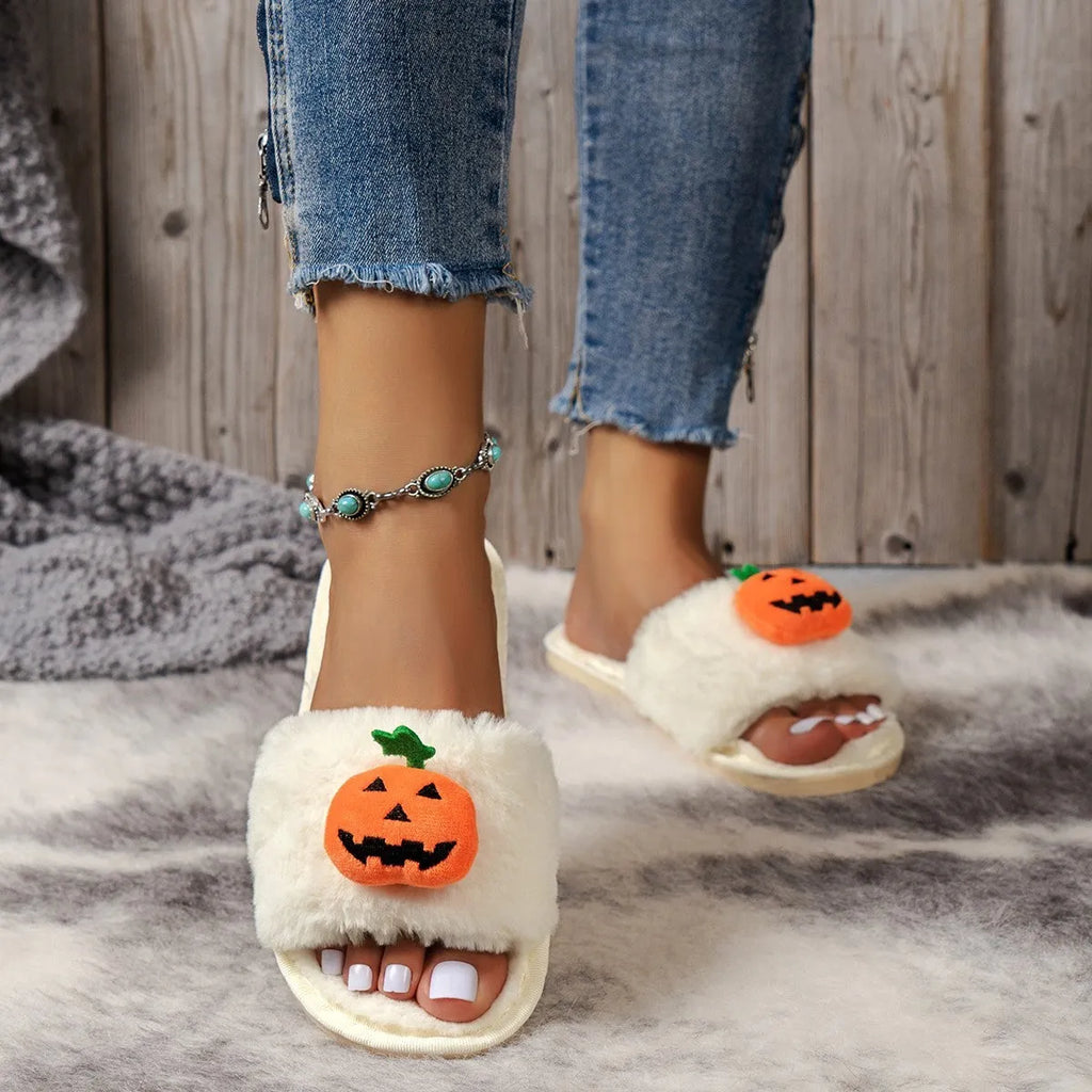 Yellow and white Halloween pumpkin cartoon design plush slippers with an open toe and textured sole.