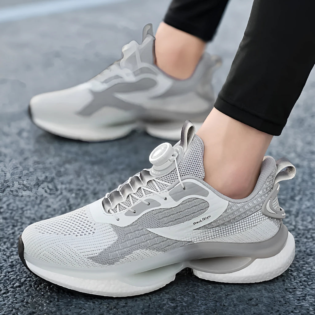 Men's white rotating buckle running shoe with Fly-knit mesh upper and low-top design.