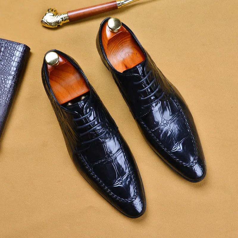 Men's black and brown leather loafers with alligator pattern and a horsebit buckle on a low rubber sole.