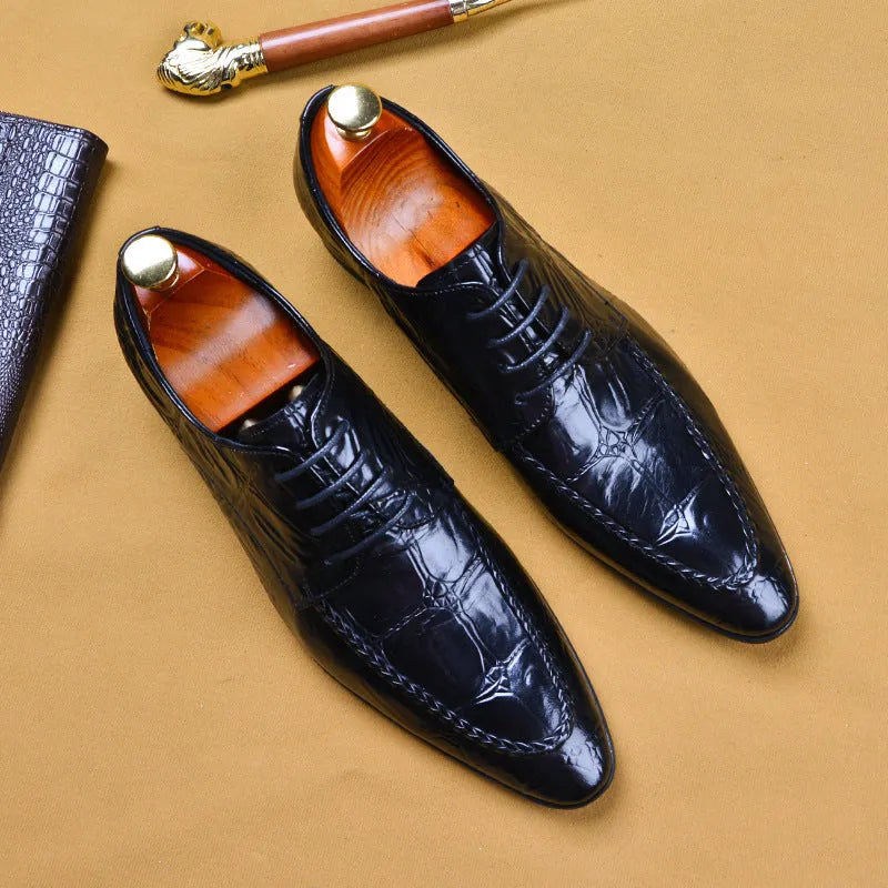 Men's black and brown leather loafers with alligator pattern and a horsebit buckle on a low rubber sole.