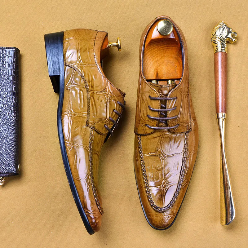 Men's black and brown leather loafers with alligator pattern and a horsebit buckle on a low rubber sole.