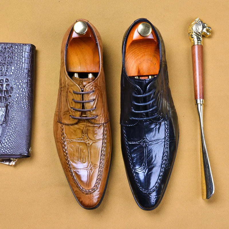 Men's black and brown leather loafers with alligator pattern and a horsebit buckle on a low rubber sole.