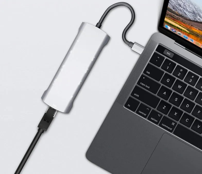 Grey aluminium USB-C docking station with HDMI, VGA, and USB ports on 140mm cable