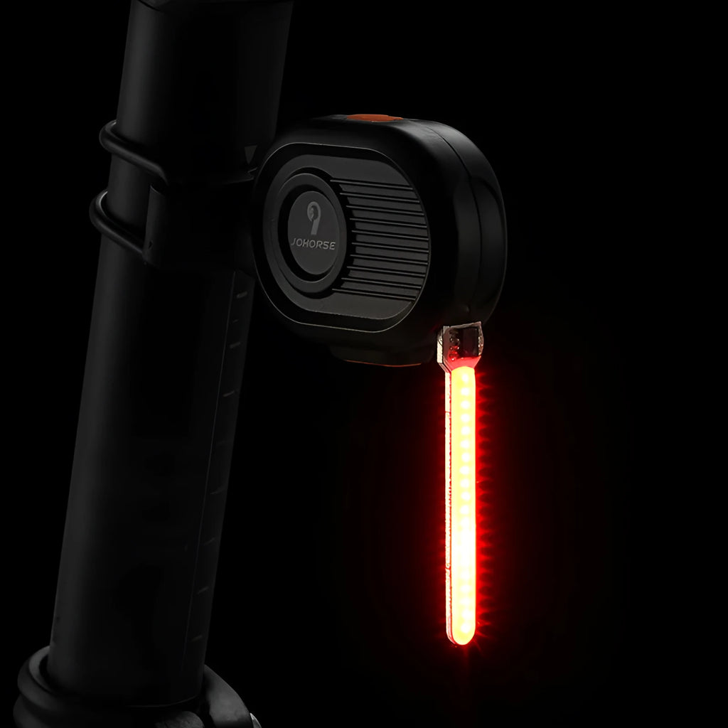 Blue waterfall effect bicycle tail light mounted on a bike seat post, showing dynamic LED light pattern.