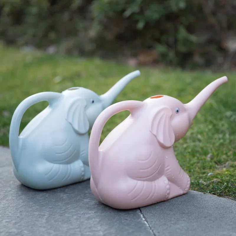 Pink plastic baby elephant-shaped watering can with a long nozzle and handle.