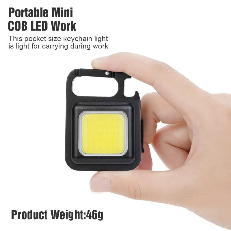 Black aluminium alloy USB rechargeable keychain torch with magnetic base and foldable handle.