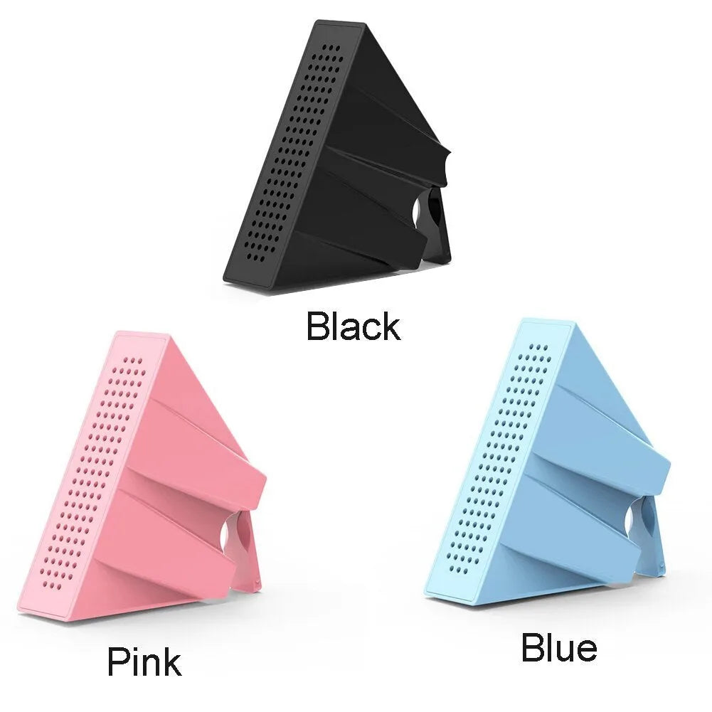 A small black plastic phone amplifier stand holding a smartphone on a desktop.