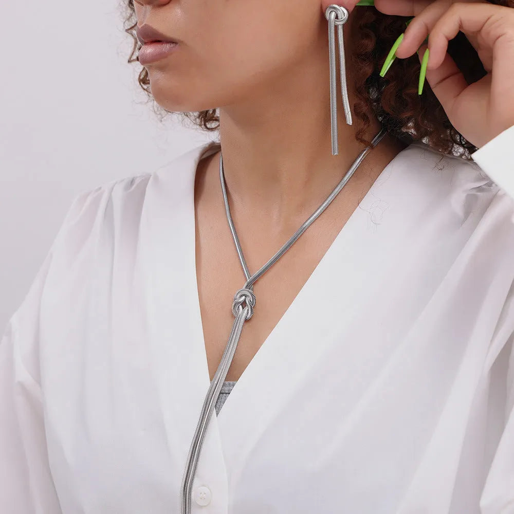 Gold knotted tassel pendant on titanium steel snake chain necklace with matching electroplated earrings