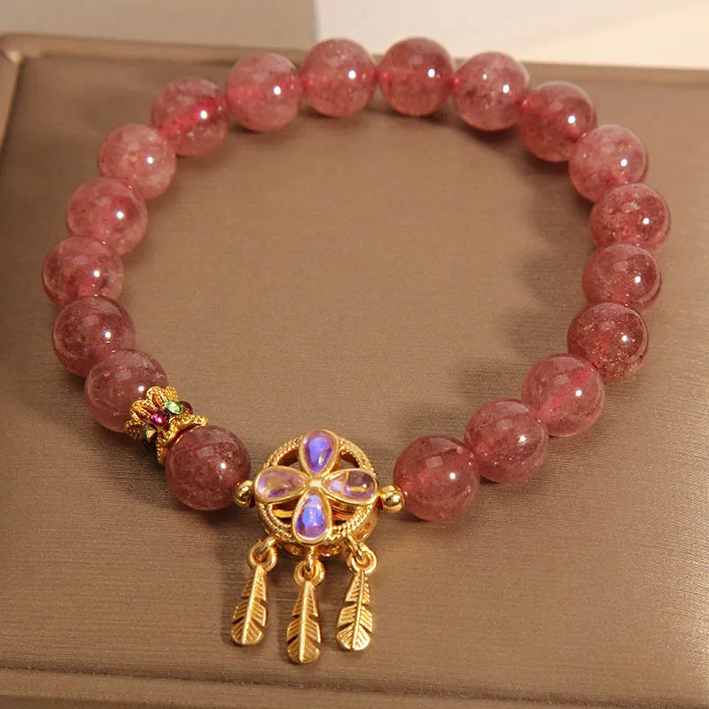 Natural strawberry quartz bracelet for women with a four-leaf dream catcher pendant on an adjustable chain.
