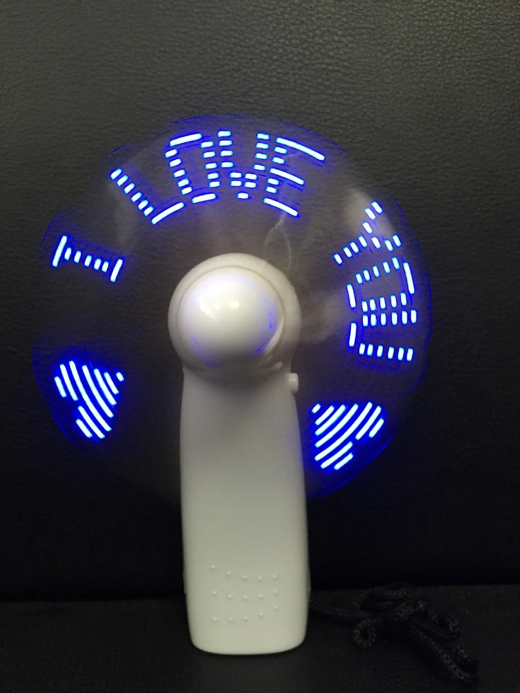 White handheld mini fan with LED flashing love pattern display