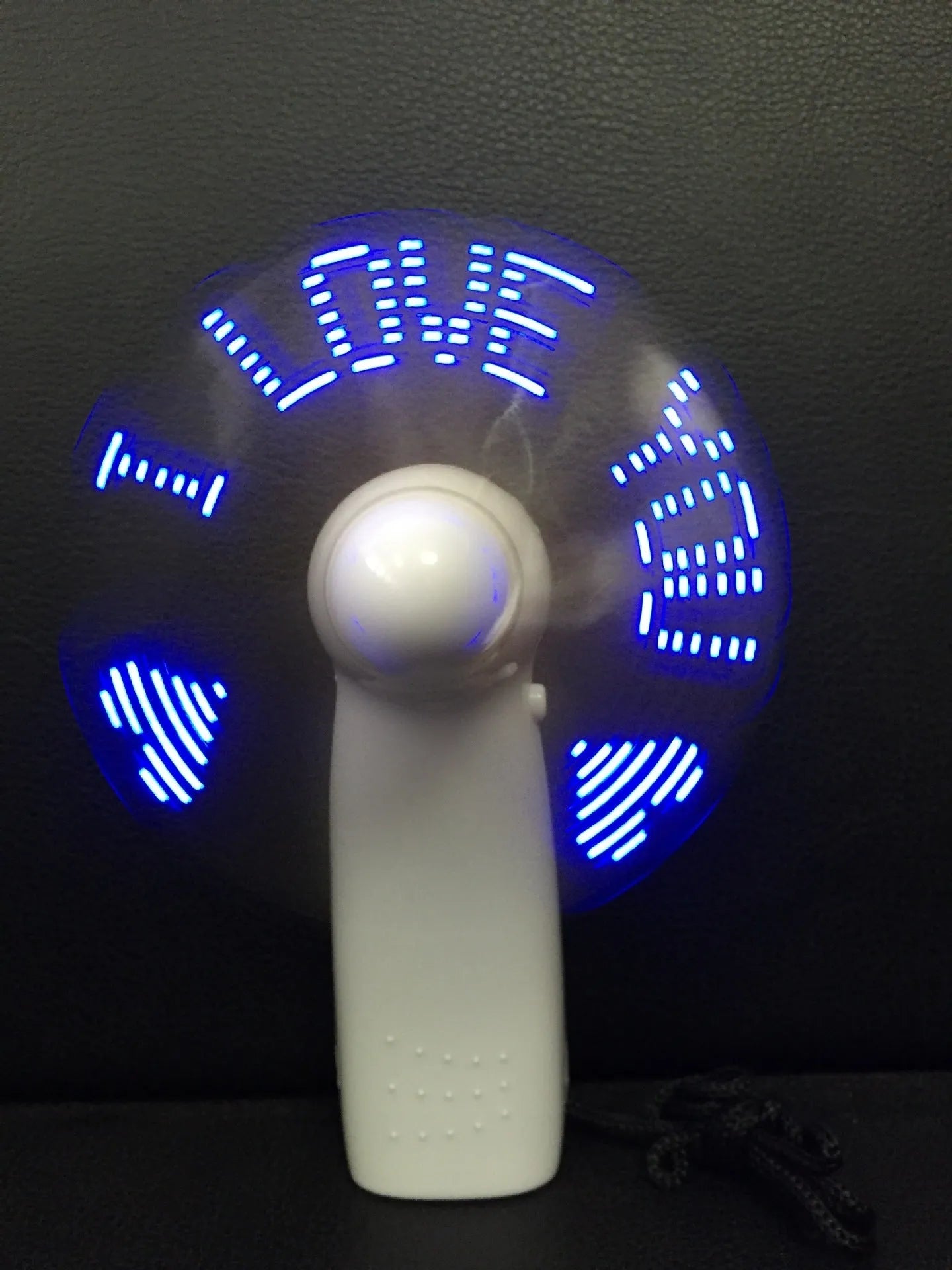 White handheld mini fan with LED flashing love pattern display
