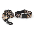 Brown leopard print dog collar and leash set with black buckle on a green background