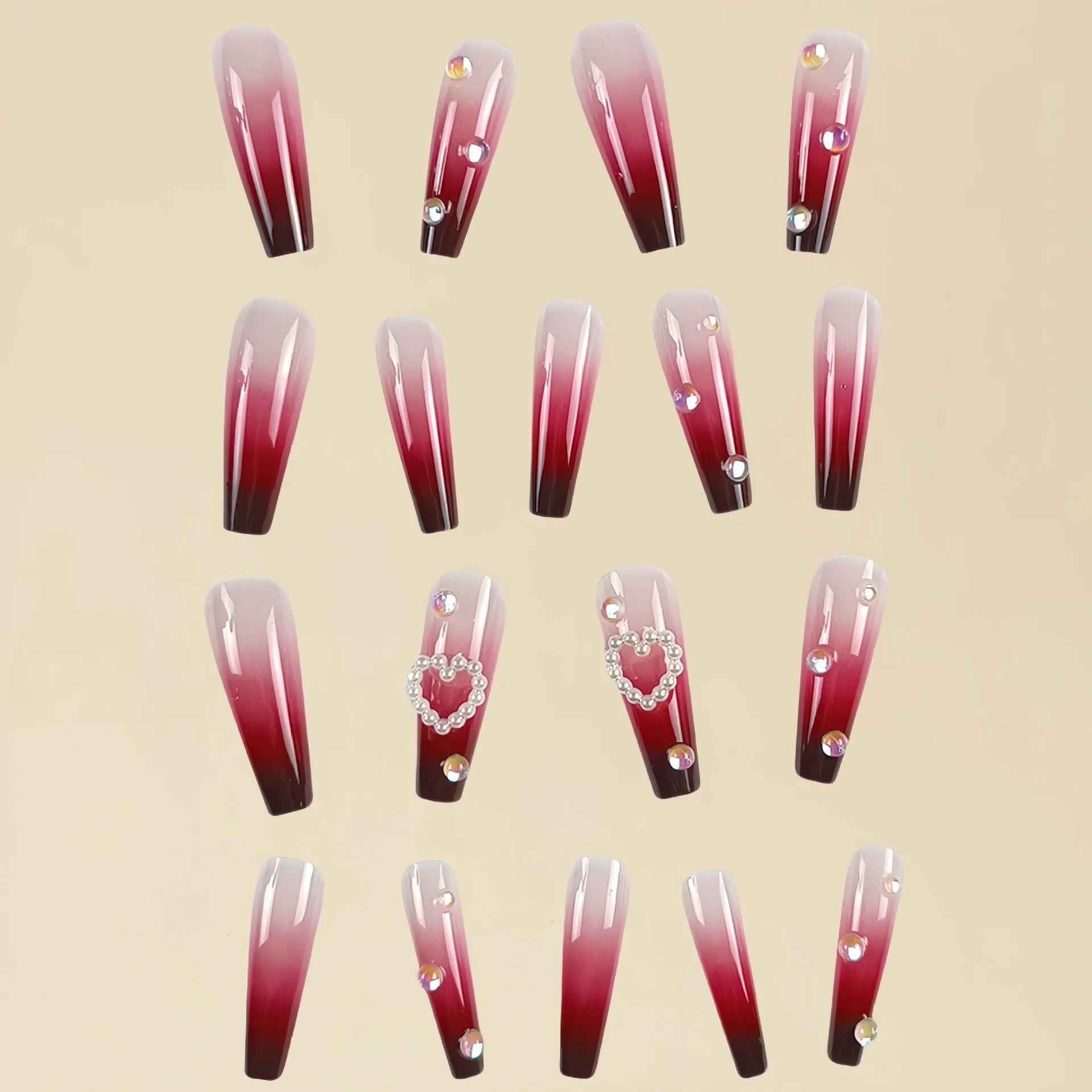 Set of long wine red gradient fake nail tips with pearl and heart design on a plaid pattern, shown with jelly glue and rubbing clause.