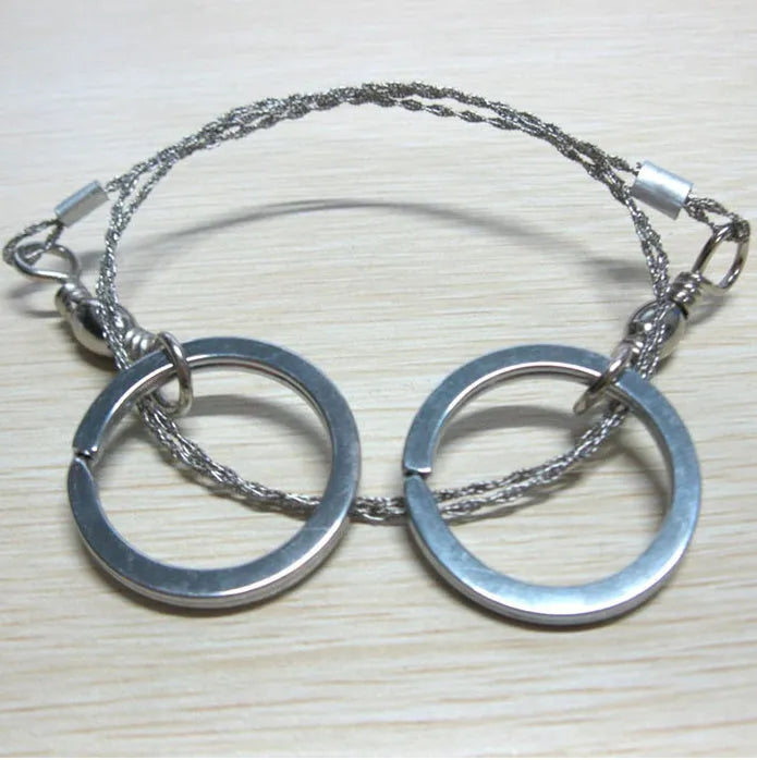 Survival wire saw with stainless steel blade, pull ring, and hoop handles for outdoor cutting