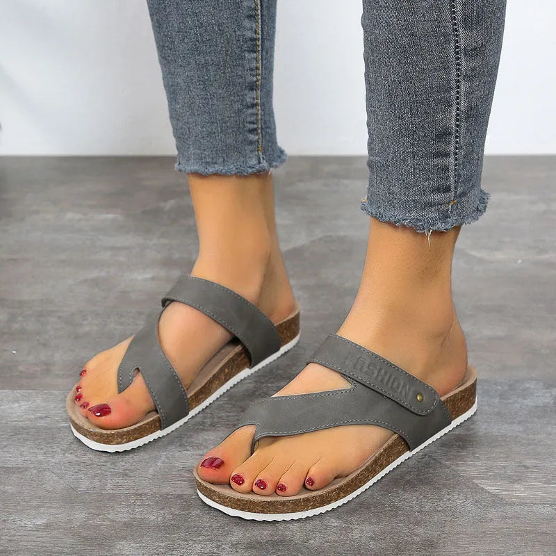 Solid colour thick-soled flat toe ring flip-flops on a white background.