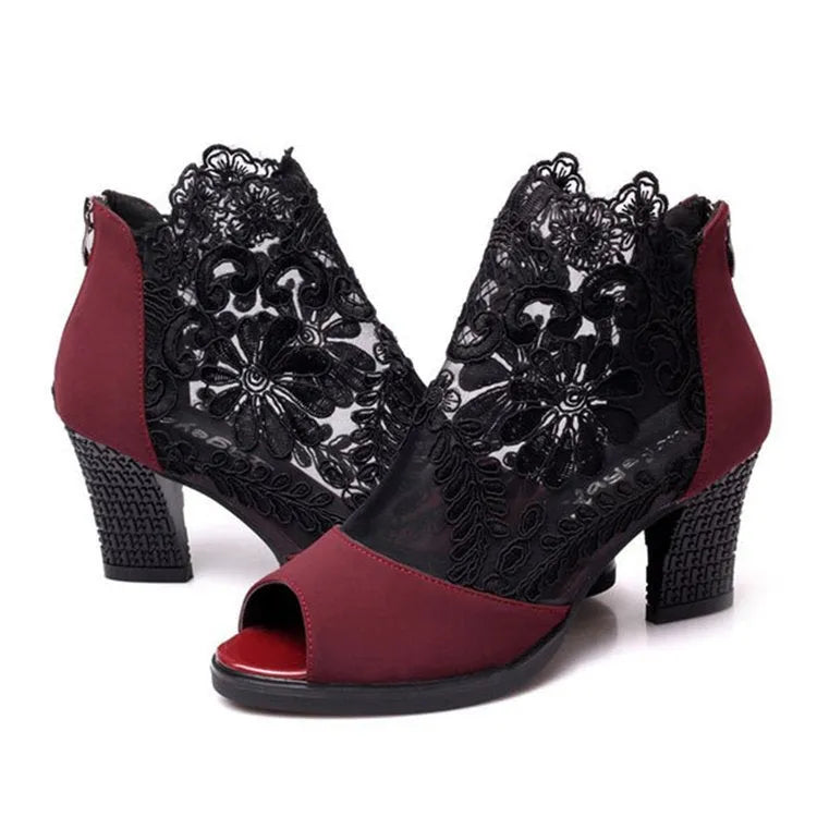 Women's black lace gladiator sandals with square heels and zip closure showing flower detailing