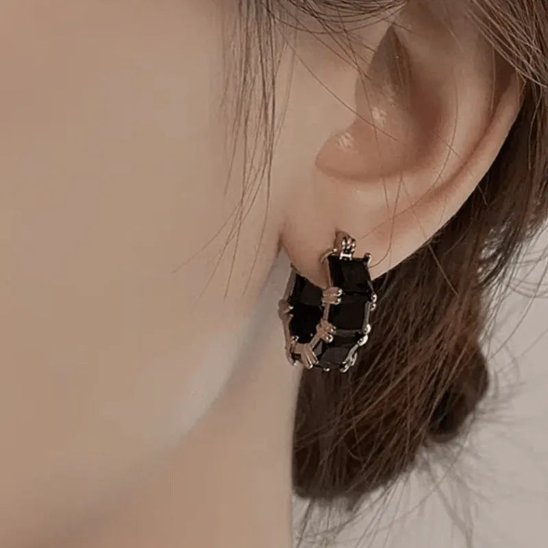 Geometric U-shaped gold earrings with round crystal zirconium stones in black, pink, or white options