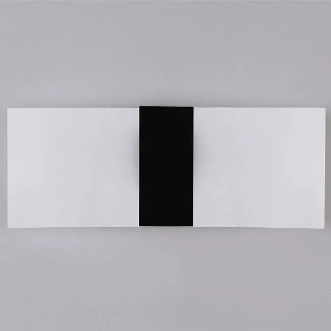 Modern acrylic LED wall lamp in black finish mounted on a corridor wall measuring 27x10cm