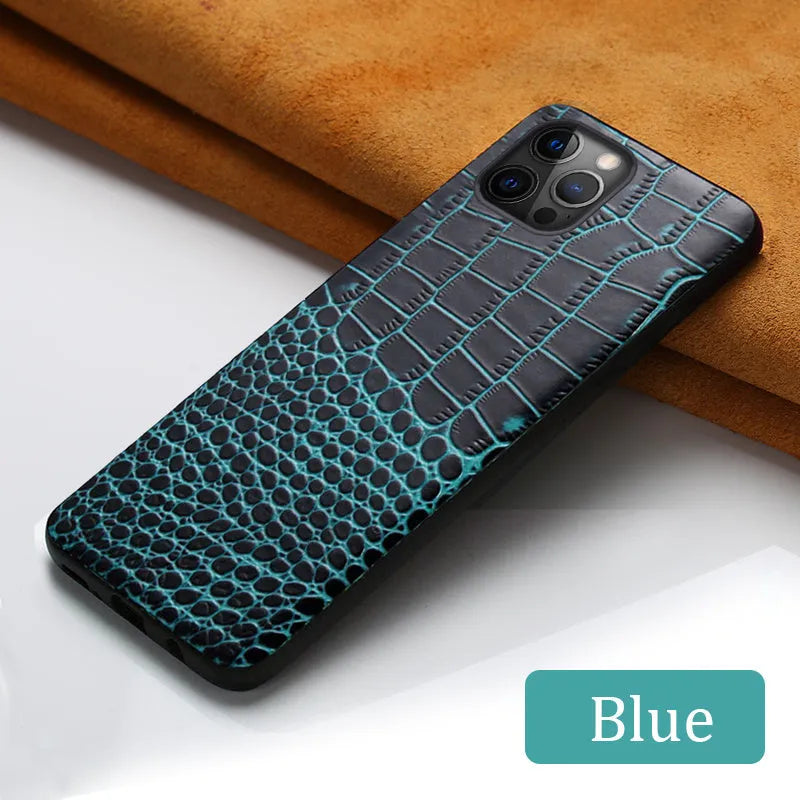 Black crocodile pattern leather back cover case for an iPhone on a wooden surface.