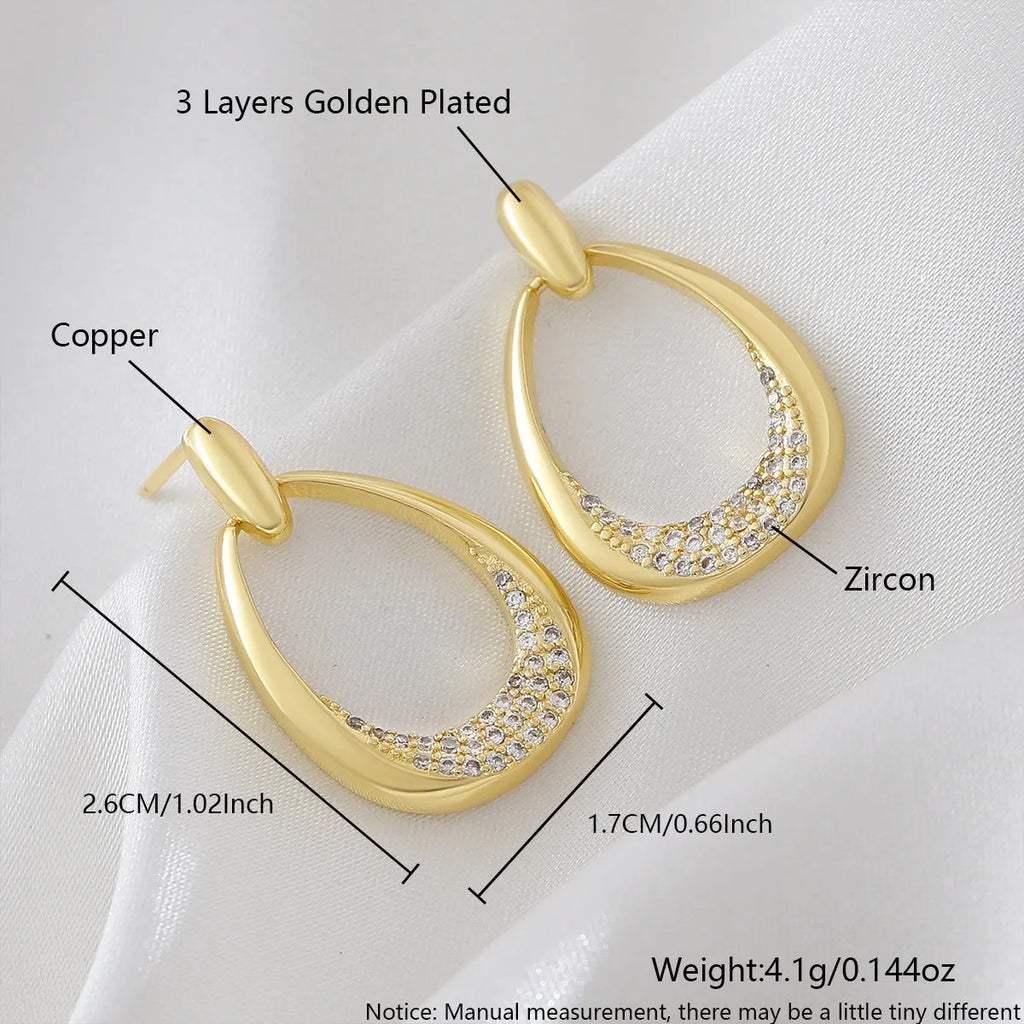 Geometric drop-shaped women's earrings in yellow gold colour with zircon design elements