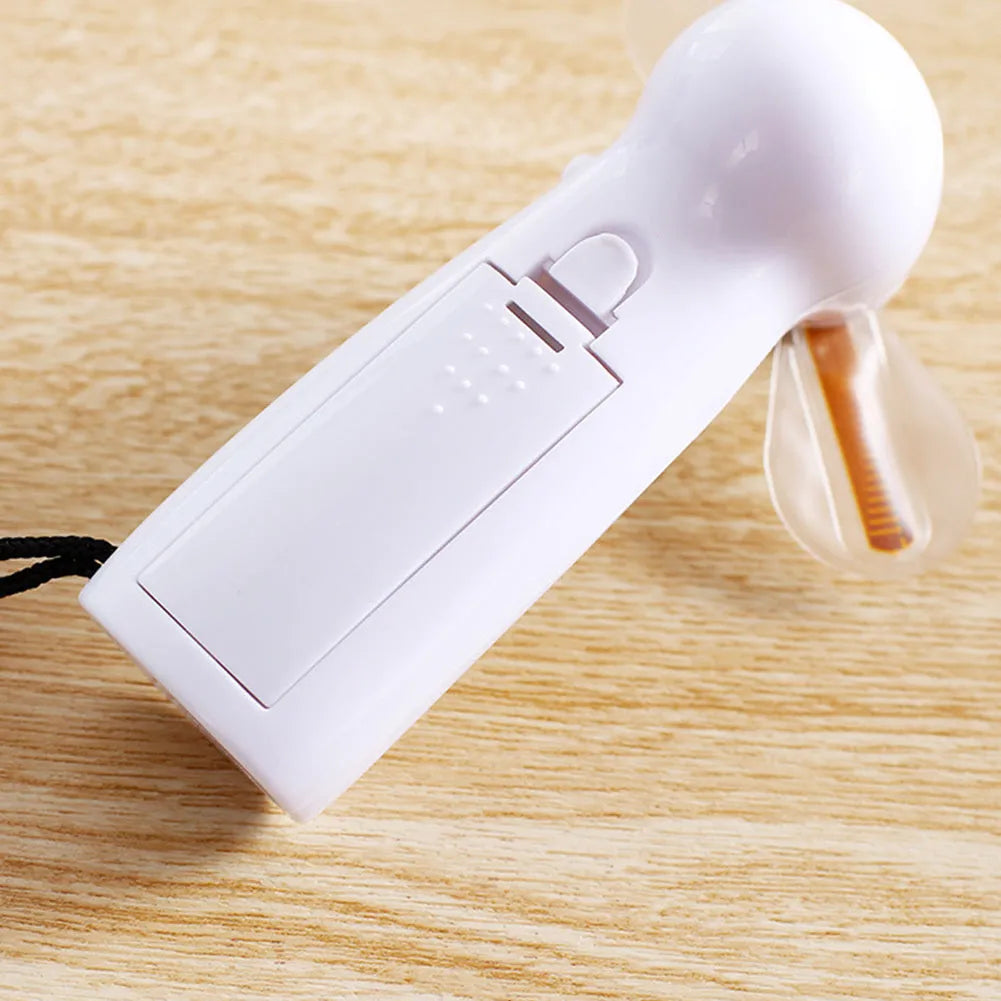 White handheld mini fan with LED flashing love pattern display