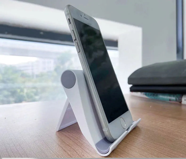Black PE folding mobile phone stand holding a tablet at an angle on a desktop.