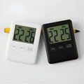 Black and white digital kitchen timer with magnetic back showing countdown display on 85mm circular face