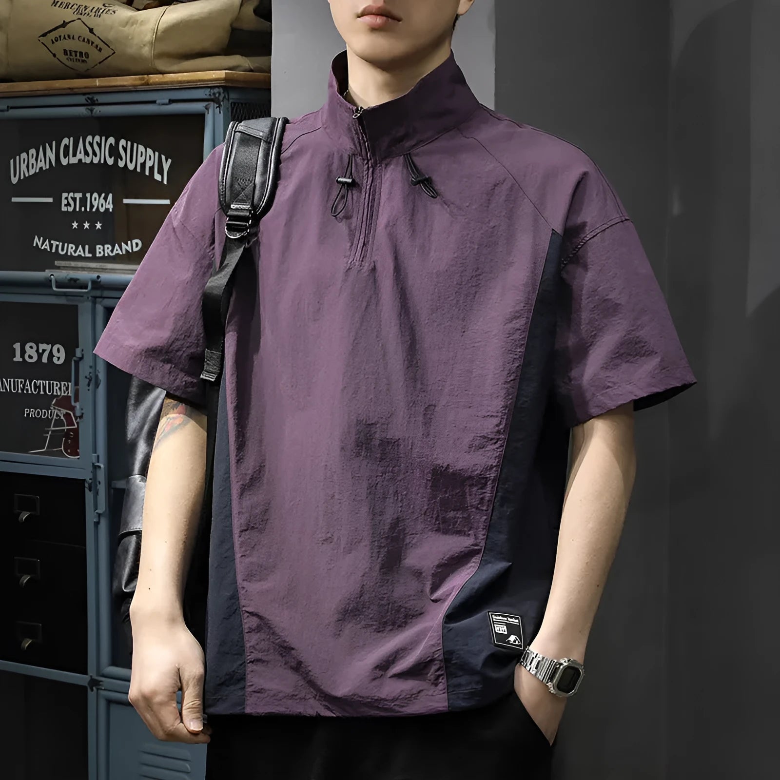 Brown men's loose fit short sleeve shirt with a half-zip stand collar, shown flat.
