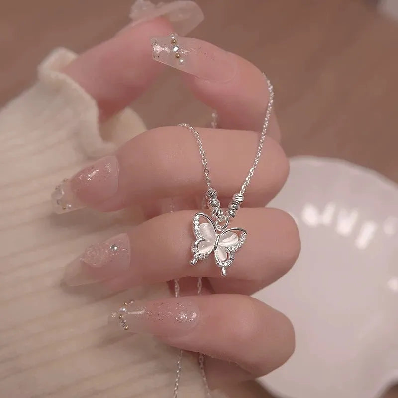 Women's silver butterfly necklace on a cross chain, made from 925 sterling silver with an adjustable length.