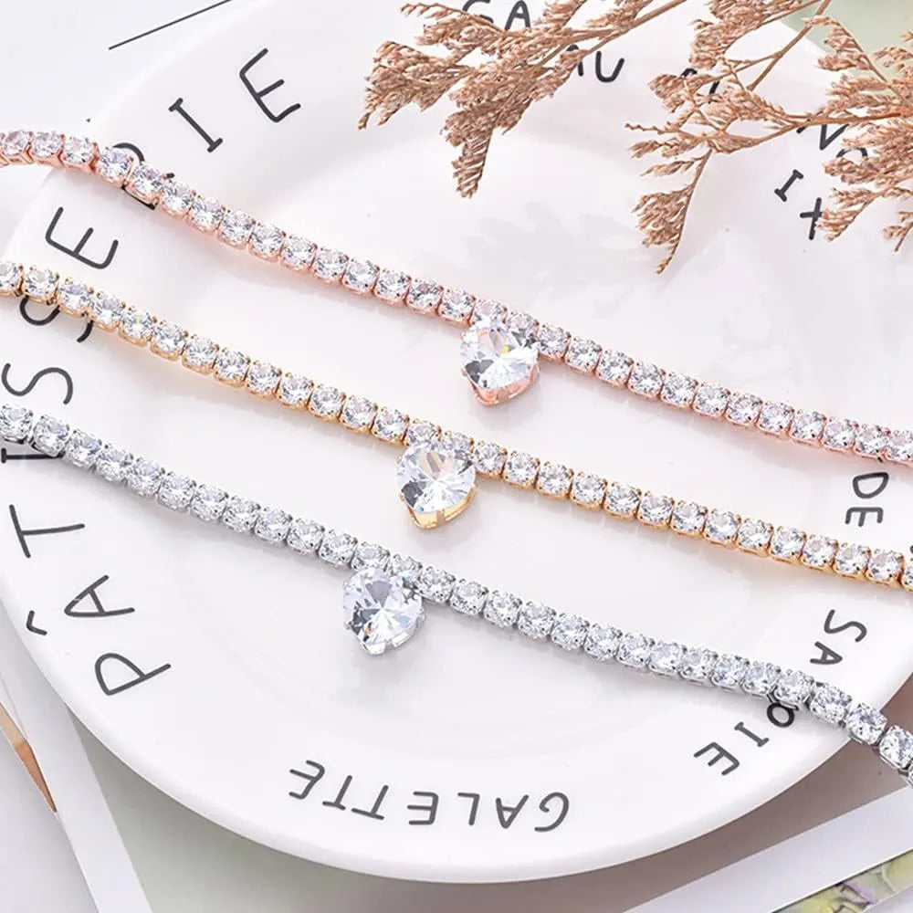 Gold metallic pet collar with a heart-shaped rhinestone design and an extension chain.