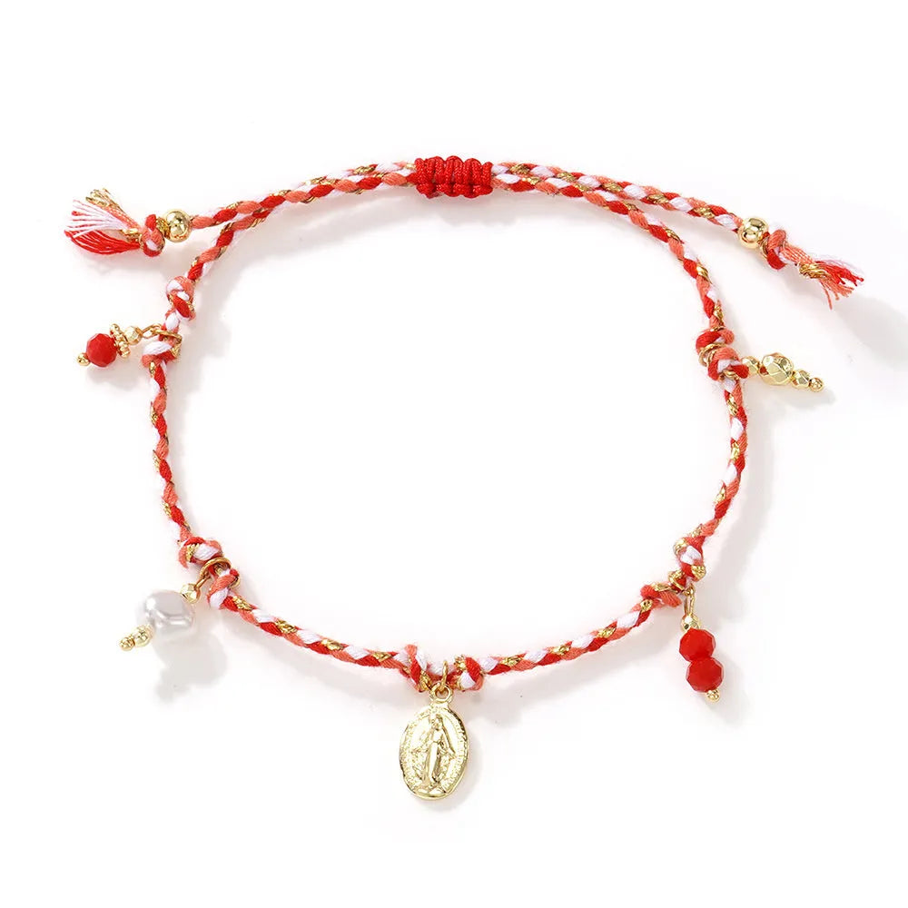 Ethnic style hand-woven bracelet made from colourful braided rope on woman's wrist