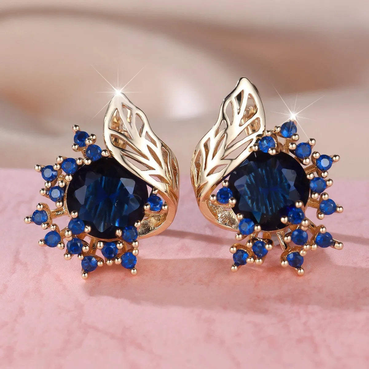 Round flower feather design earrings with champagne gold setting and coloured zircon stones.