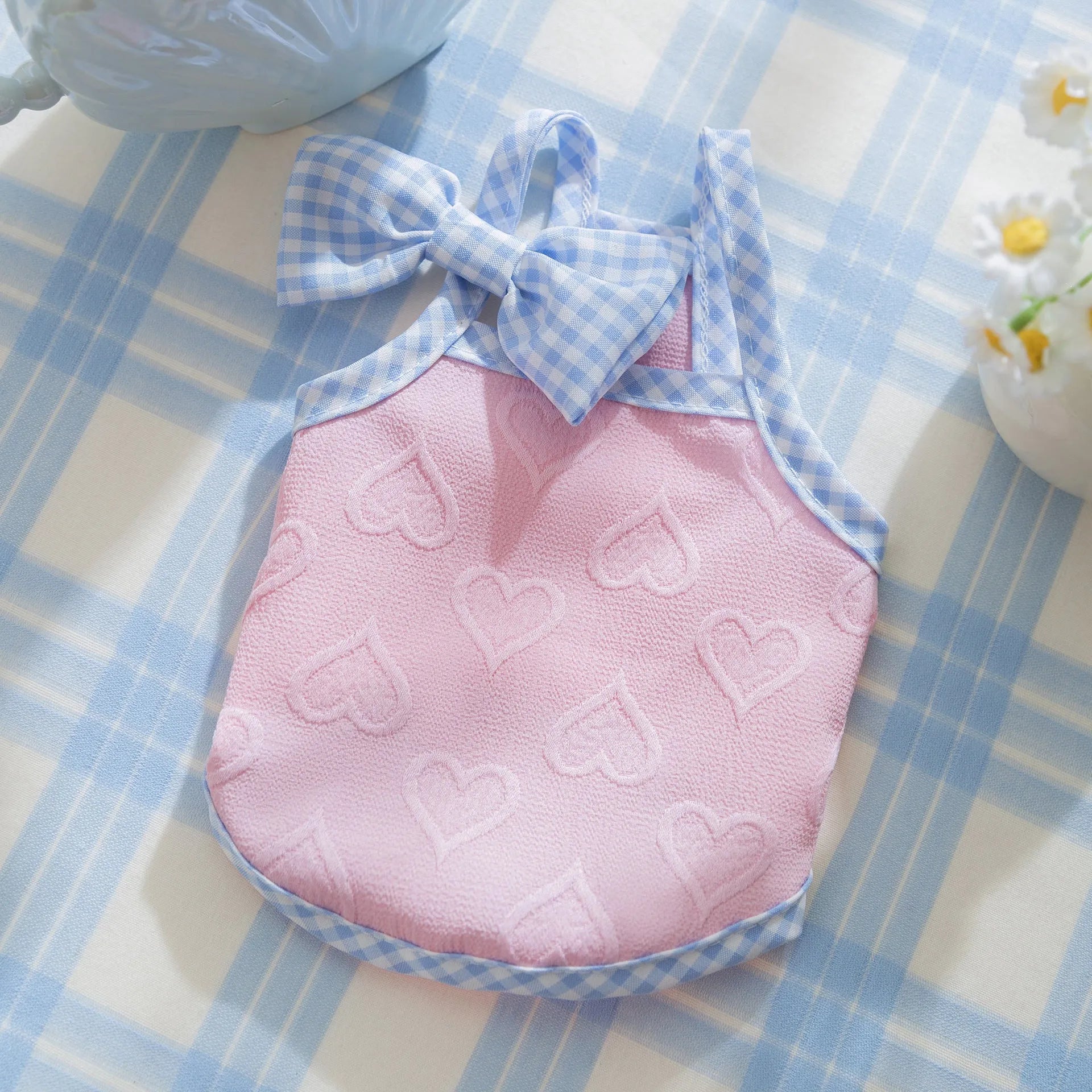 Small dog wearing heart texture bow suspenders vest in elastic material