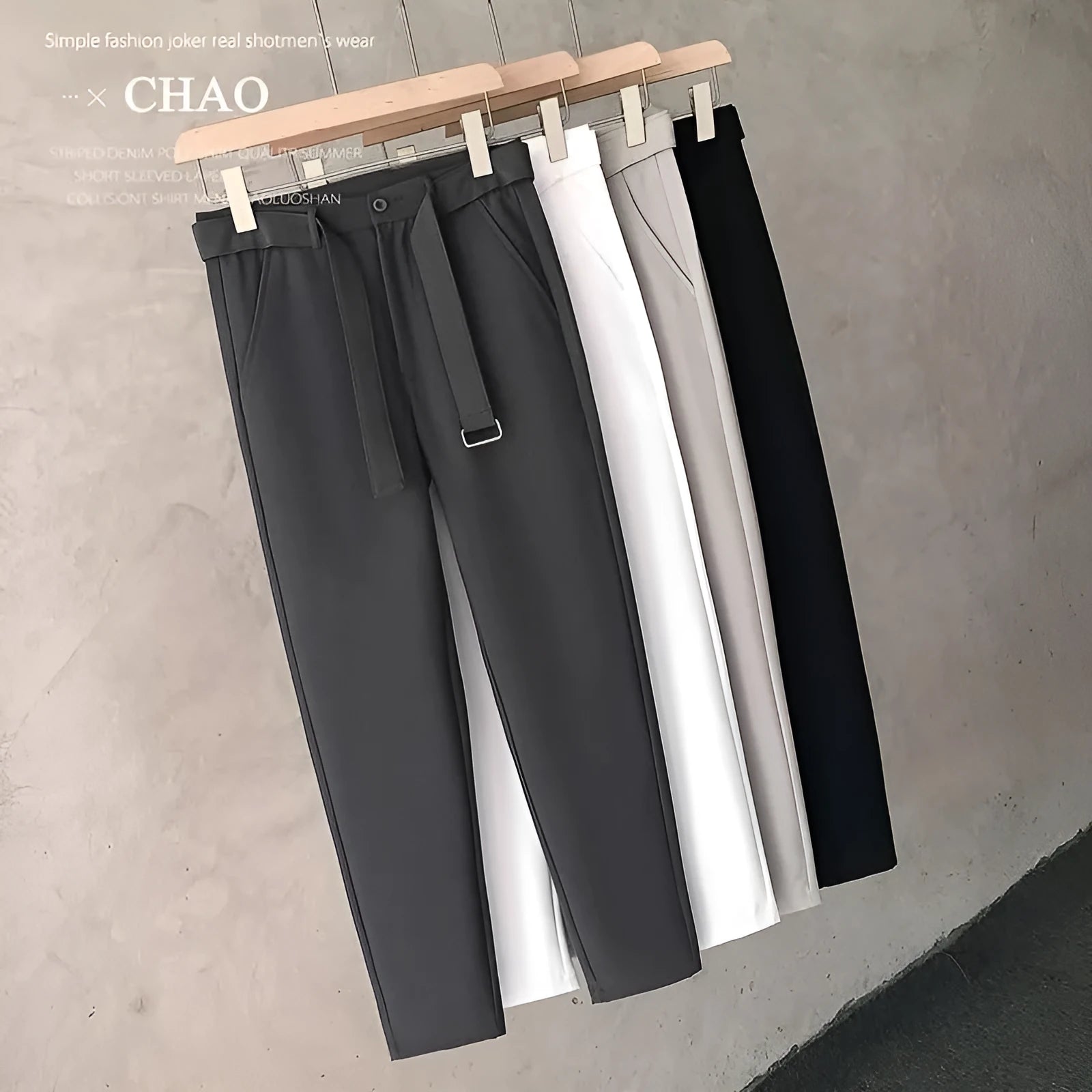 Boy wearing slim straight tapered wool trousers in a grey colour, showing the straight leg opening and belt loops.