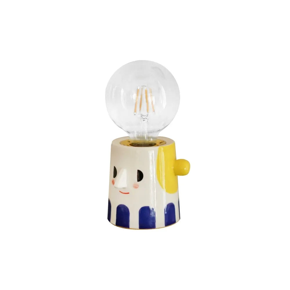 Handmade ceramic bedside lamp with ball headlight design on wooden surface