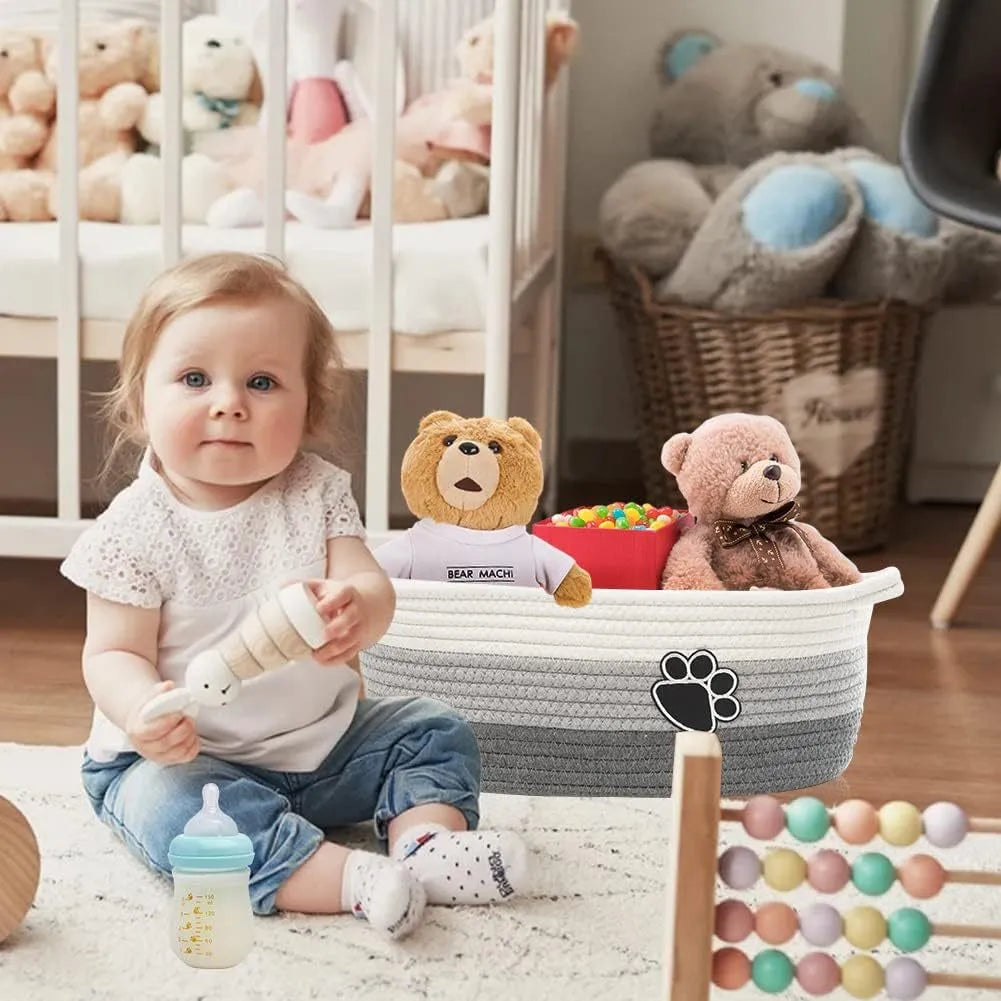 Light beige handmade cotton rope storage basket with wooden details and a handle.