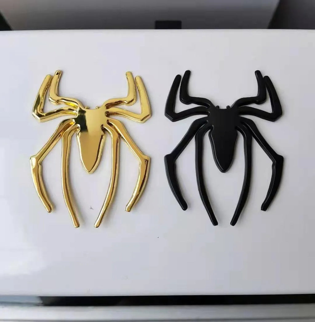 Three-dimensional metal spider bumper sticker in zinc alloy on a car bumper.
