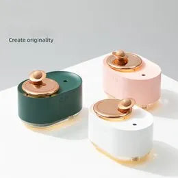 Green rotating planet-shaped desktop humidifier with night light on a wooden table.