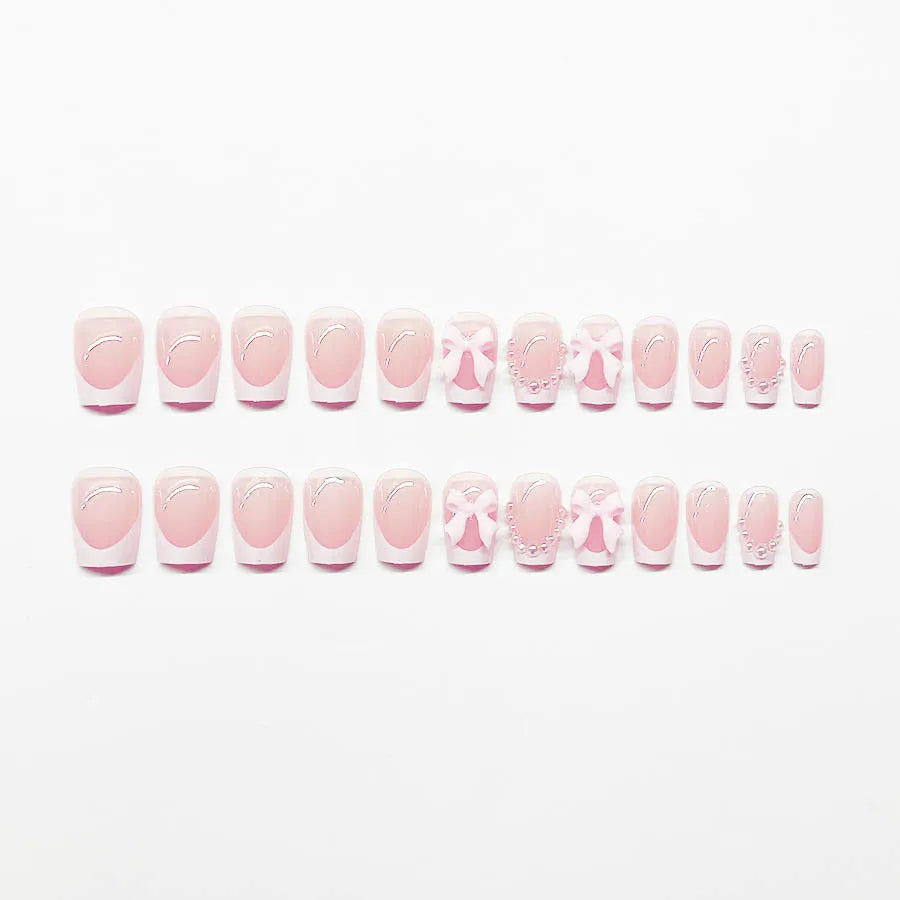 Set of short white French manicure nail art stickers showing bow, tulip, starry sky, and leopard print patterns.